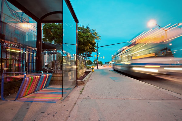 bus stop with passing cars and busses