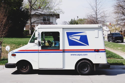 usps-truck-stopped-on-street-in-neighborhood-mail-route