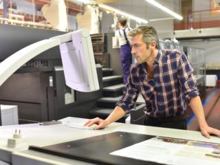 bigstock Man working on printing machin 114378377 scaled 1