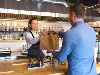 bigstock Smiling Young Waiter Giving Fo 282097294 1