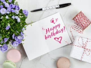 Happy Birthday Card Beside Flower, Thread, Box, and Macaroons Spot UV Coated Postcards