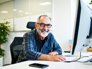 Senior graphic designer in office - Catdi Houston professional printing